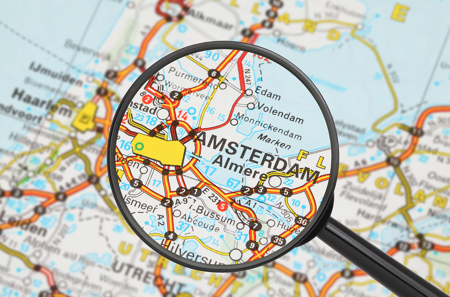 Destination Amsterdam (magnifying Glass) Tourist conceptual image: Destination - Amsterdam (with magnifying glass)