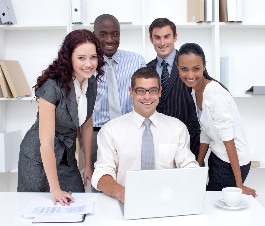 International businessteam using a laptop together in office