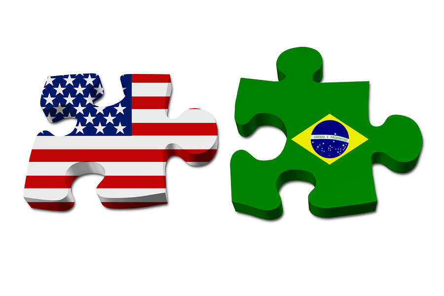 US working with Brazil Puzzle pieces with the US flag and Brazilian flag isolated over white