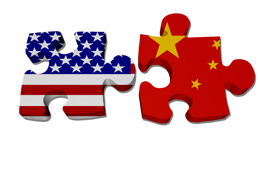 Puzzle pieces with the US flag and Chinese flag isolated over white