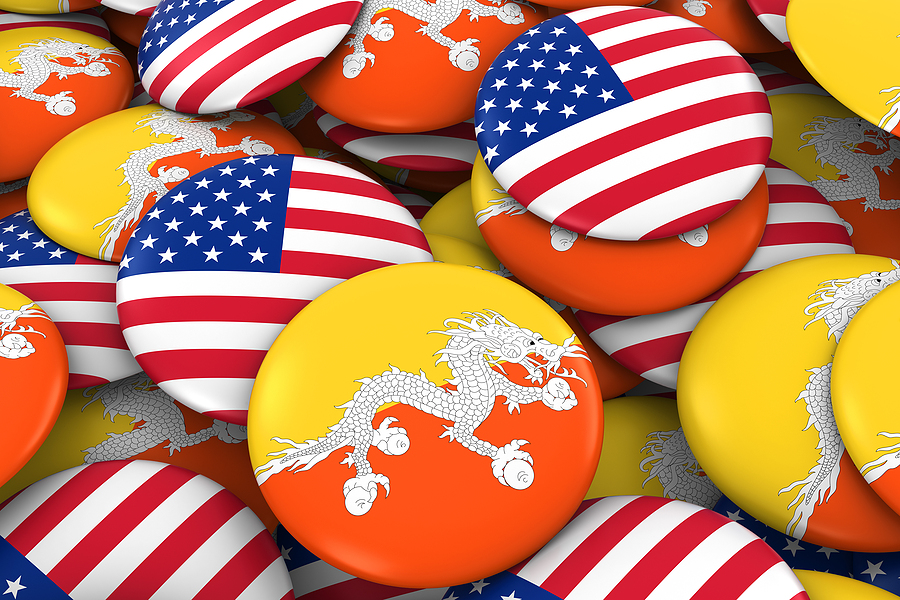 USA and Bhutan Badges Background - Pile of American and Bhutanese Flag Buttons 3D Illustration